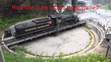 a western maryland train on a turntable with people watching