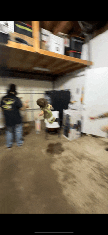 a blurry photo of people in a garage with a man wearing a shirt that says ' texas rangers ' on it