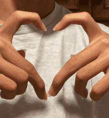 a person making a heart with their hands