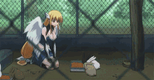 a girl with wings is kneeling down in front of a cage with rabbits and a bowl of food .