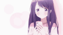 a girl with purple hair is holding a pink cell phone in her hand