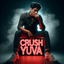 a man is sitting next to a sign that says crush yuva