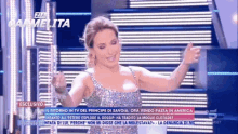 a woman in a sequined dress is dancing on a television screen that says zia gambetta