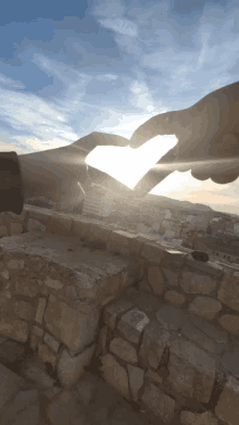 a couple making a heart with their hands