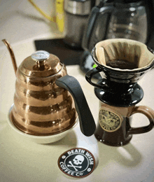 a death wish coffee co. mug sits next to a coffee maker