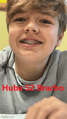 a young boy with braces on his teeth is smiling with the name huba 52 bracho in red