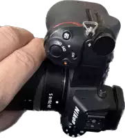 a nikon camera is being held by someone