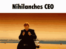 a man in a suit stands in front of a car with the words " nihilanches ceo " on the bottom