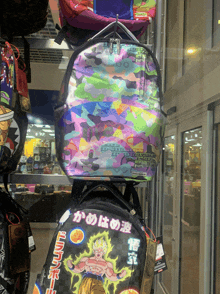 a stack of backpacks including one that says dragon ball