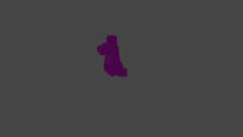 a purple object is floating in the air on a grey background .