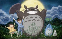 a group of children standing next to a totoro holding an umbrella in front of a full moon .