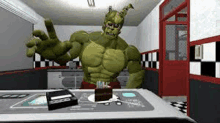 a hulk statue is standing next to a cake on a table .