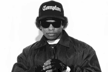 a man wears a compton hat and sunglasses