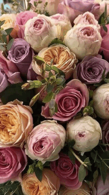 a bunch of different colored roses are laying on a table .