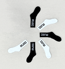 a circle of black and white socks with the word muse written on them