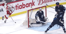 a hockey game is being played in front of a budweiser advertisement