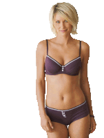 a woman in a purple bra and purple shorts smiles