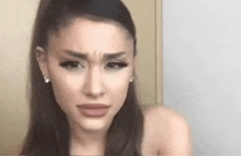 ariana grande is making a funny face while talking to the camera .