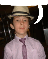 a young boy wearing a hat and tie is standing next to a speech bubble .