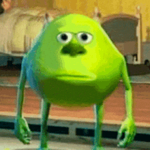 a green monster from monsters inc is standing in front of a bed in a bedroom .