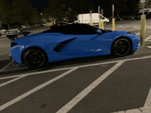 a blue car is parked in a parking lot