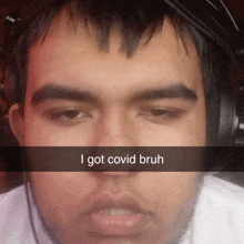 a man wearing headphones says i got covid bruh on his face