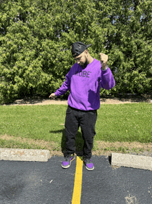 a man wearing a purple sweater that says kobe