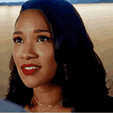 a close up of a woman with red lipstick and a necklace .