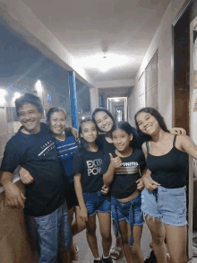 a group of people posing for a picture with one girl wearing a united shirt