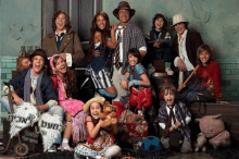 a group of people posing for a picture with a sign that says ' coca cola '