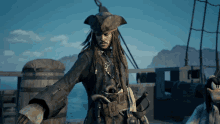 a man with dreadlocks and a pirate hat stands on a deck