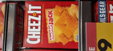 a box of cheez-it cheddar jack baked snack crackers sits on a shelf