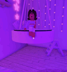 a girl is sitting on a purple swing in a room