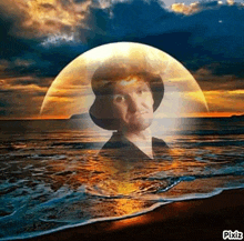 a man in a cowboy hat is standing on a beach with a full moon in the background .