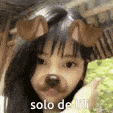 a girl wearing a dog mask with the words solo de lili written on it .