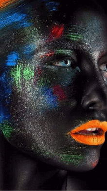 a close up of a woman 's face with paint on it