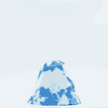 a blue and white tie dye bucket hat on a white surface