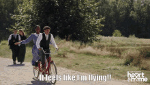 a group of people riding bicycles on a dirt road with the words " it feels like i 'm flying "