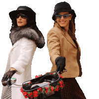 two women wearing hats and sunglasses are holding a bicycle