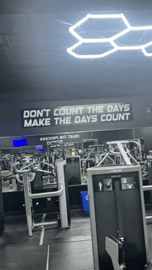 a gym with a sign that says " don 't count the days make the days count "