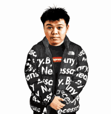 a man wearing a black jacket that says supreme