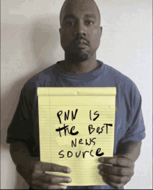 a man holds up a yellow notepad that says pnn is the best news source