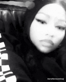 a black and white photo of a woman with the words hereformsminaj above her