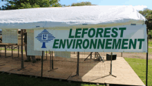 a white tent with a sign that says leforest environnement