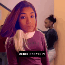 a girl wearing a purple shirt has the hashtag #crookznation on the bottom