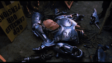 a robot is laying on the ground in front of a sign that says " our pension "