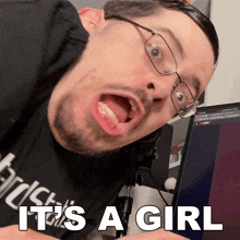 a man wearing glasses and a black shirt with the words it 's a girl on the bottom