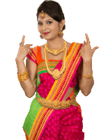 a woman wearing a colorful saree and gold jewelry is making a funny face