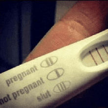 a pregnancy test that says pregnant not pregnant slut on it