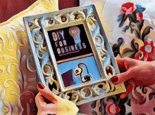 a person holding a picture frame that says diy for business on it